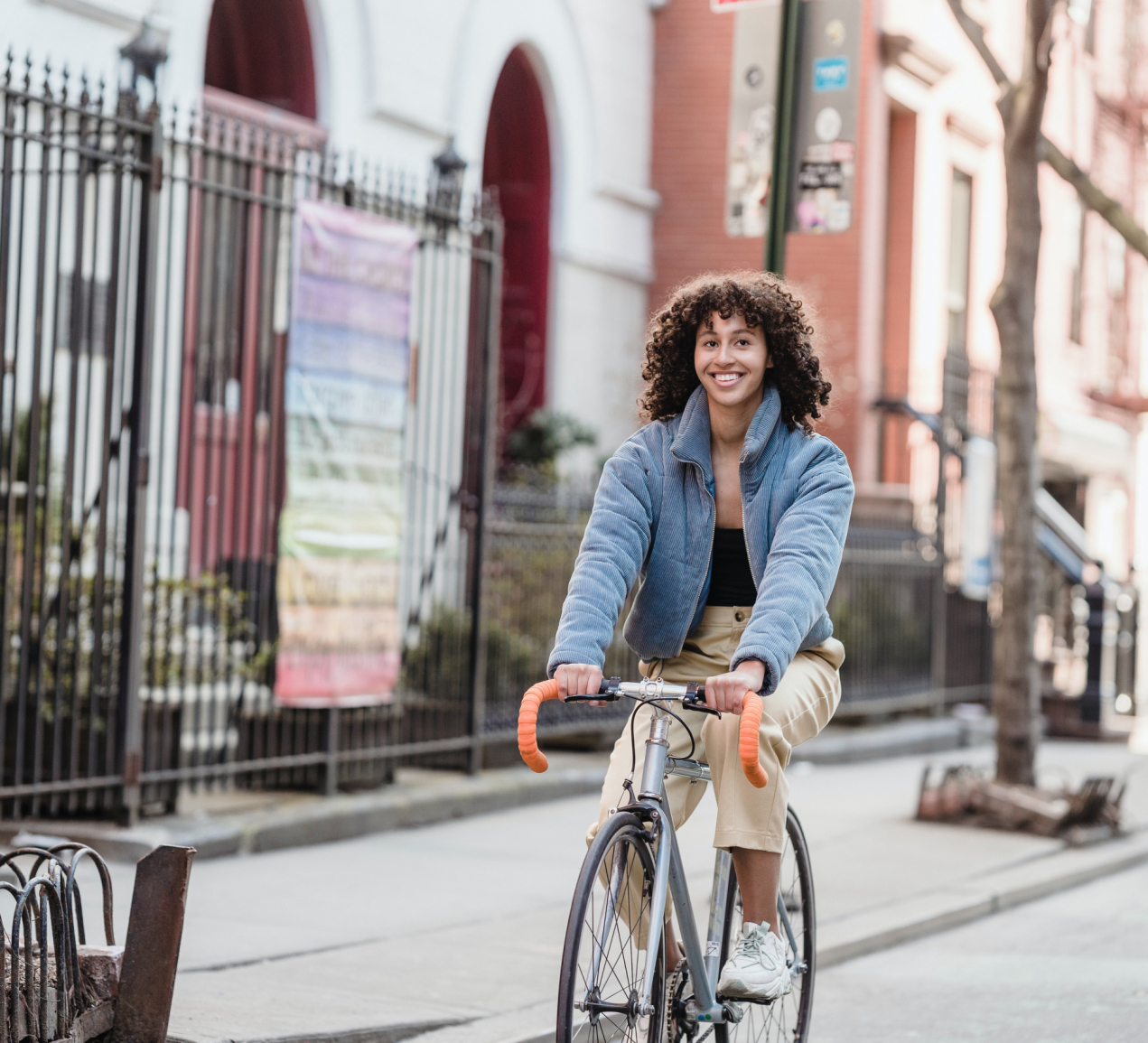 Woman cycling bike down street